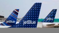 FILE PHOTO: JetBlue Airways aircraft are pictured at departure gates at John F. Kennedy International Airport in New York June 15, 2013. REUTERS/Fred Prouser/File Photo
