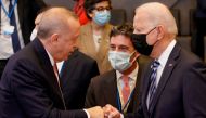 Turkey's President Tayyip Erdogan fist bumps U.S. President Joe Biden during a plenary session at a NATO summit in Brussels, Belgium, June 14, 2021. Olivier Matthys/Pool