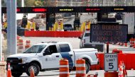 FILE PHOTO: A U.S. Customs and Protection vehicle stands beside a sign reading that the border is closed to non-essential traffic at the Canada-United States border crossing at the Thousand Islands Bridge, to combat the spread of the coronavirus disease (
