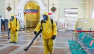 Specialists wearing personal protective equipment (PPE) spray disinfectant while sanitizing the Rizhsky Railway Station, one of the measures to curb the spread of the coronavirus disease (COVID-19), in Moscow, Russia June 17, 2021. Moscow Division of Russ