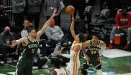 Atlanta Hawks guard Trae Young (11) puts up a shot against Milwaukee Bucks center Brook Lopez (11) in the second quarter during game one of the Eastern Conference Finals for the 2021 NBA Playoffs at Fiserv Forum.   Michael McLoone 