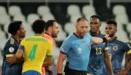 Soccer Football - Copa America 2021 - Group B - Brazil v Colombia - Estadio Nilton Santos, Rio de Janeiro, Brazil - June 23, 2021 Colombia players remonstrate with referee Nestor Pitana REUTERS/Sergio Moraes

