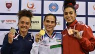 Oksana Chusovitina poses with her gold medal along with other gymnasts yesterday.