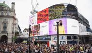 Demonstrators gather at Piccadilly Circus during a Save Our Scene protest, amid the coronavirus disease (COVID-19) pandemic, in London, Britain June 27, 2021. REUTERS/Henry Nicholls

