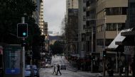 Pedestrians cross an unusually quiet street in the city centre during a lockdown to curb the spread of a coronavirus disease (COVID-19) outbreak in Sydney, Australia, June 29, 2021. REUTERS/Loren Elliott