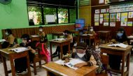 Elementary school students wearing face masks and face shields attend class, as schools reopen amid the coronavirus disease (COVID-19) pandemic, in Jakarta, Indonesia April 7, 2021. REUTERS/Ajeng Dinar Ulfiana/File Photo