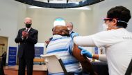 FILE PHOTO: U.S. President Joe Biden applauds a man as he receives a vaccine at the coronavirus disease (COVID-19) vaccination site at Virginia Theological Seminary in Alexandria, Virginia, U.S., April 6, 2021. REUTERS/Kevin Lamarque
