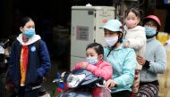 A family wears protective masks as they ride a motorbike in the street amid the coronavirus disease (COVID-19) outbreak in Hanoi, Vietnam, January 29, 2021. REUTERS/Thanh Hue/File Photo/File Photo