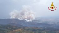 An aerial view from a helicopter shows a large wildfire that broke out near Santu Lussurgiu, Sardinia, Italy July 25, 2021. Vigili del Fuoco/Handout via REUTERS