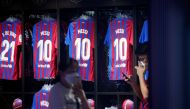 Shirts with Barcelona's Lionel Messi's name hang in the club store outside the Camp Nou. (REUTERS/Albert Gea)