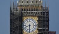 Workers stand on scaffolding underneath one of the clock faces on the Elizabeth Tower, more commonly known as Big Ben, as hands and dials are seen restored to the original Prussian blue colouring, whilst renovation works continue at the Houses of Parliame