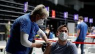 A man receives a dose of the coronavirus disease (COVID-19) vaccine during a trial run of the national vaccination centre located inside the O2 Arena in Prague, Czech Republic, April 9, 2021. REUTERS/David W Cerny