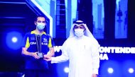 Qatar Table Tennis Association President Khalil Ahmed Al Mohannadi presenting the WTT trophy to WTT Star Contender Doha 2021 men's singles champion Hugo Calderano of Brazil at Lusail Sports Arena, yesterday.