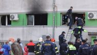 Emergency personnel assist the people evacuated after a fire broke out at the intensive care unit of a COVID-19 hospital in Constanta, Romania, October 1, 2021. Inquam Photos/Costin Dinca via REUTERS