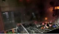 Jets of water are sprayed as a fire blazes at Cheng Chung Cheng building in Kaohsiung, Taiwan in this still frame obtained from social media video dated early October 14, 2021. CHANG YU CHEN /via REUTERS