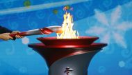 Beijing Communist Party Secretary and President of the Beijing 2022 Organising Committee Cai Qi transfers the Olympic flame to a cauldron at the ceremony to welcome the flame for the Beijing 2022 Winter Olympics, in Beijing, China October 20, 2021. REUTER