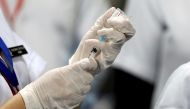 A healthcare worker fills a syringe with a dose of Bharat Biotech's COVID-19 vaccine called COVAXIN, during the coronavirus disease (COVID-19) vaccination campaign at All India Institute of Medical Sciences (AIIMS) hospital in New Delhi, India, January 16, 2021. REUTERS/Adnan Abidi/File Photo