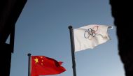 FILE PHOTO: The Chinese and Olympic flags flutter at the headquarters of the Beijing Organising Committee for the 2022 Olympic and Paralympic Winter Games in Beijing, China November 12, 2021. REUTERS/Thomas Suen/File Photo
