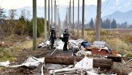 Members of theVancouver Urban Rescue Search and Rescue Canada Task Force One conduct a hazard assessment after rainstorms lashed the western Canadian province of British Columbia, triggering landslides and floods, shutting highways, in Abbottsford, British Columbia, Canada November 22, 2021. REUTERS/Jennifer Gauthier
