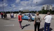 Tourists from Spain take pictures at the Revolution square in Havana, Cuba, November 23, 2021. Picture taken on November 23, 2021. REUTERS/Alexandre Meneghini
