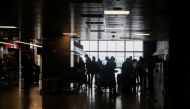 Passengers queue at the Kenya Airways ticket sales counter to book flights as several airlines have stopped flying out of South Africa, amidst the spread of the new SARS-CoV-2 variant Omicron, at O.R. Tambo International Airport in Johannesburg, South Africa, November 28, 2021. REUTERS/ Sumaya Hisham