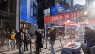 People queue at a popup COVID-19 testing site in Times Square in New York City, New York, U.S., December 3, 2021. REUTERS/Jeenah Moon