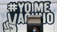 A man waits outside a mobile vaccination centre to receive a dose of Sinovac's CoronaVac coronavirus disease (COVID-19) vaccine in Santiago, Chile May 24, 2021. The sign reads ''I get vaccinated