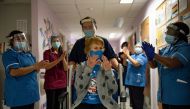 Margaret Keenan, 90, is applauded by staff as she returns to her ward after becoming the first person in Britain to receive the Pfizer/BioNTech COVID-19 vaccine at University Hospital, at the start of the largest ever immunisation programme in the British history, in Coventry, Britain December 8, 2020. Jacob King/Pool via REUTERS
