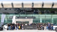 Guests and staff pose for a group photo at the Lexus driving experience. 