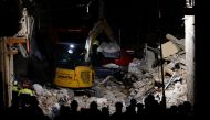Members of a rescue team work at the scene of a gas explosion in a residential building, in Ravanusa, Italy, December 12, 2021. REUTERS/Guglielmo Mangiapane
