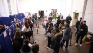 People queue at a coronavirus disease (COVID-19) vaccination centre in London, Britain, December 15, 2021. REUTERS/Hannah McKay