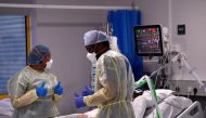 Nurses react as they treat a COVID-19 patient in the ICU (Intensive Care Unit) at Milton Keynes University Hospital, amid the spread of the coronavirus disease (COVID-19) pandemic, Milton Keynes, Britain, January 20, 2021. REUTERS/Toby Melville
