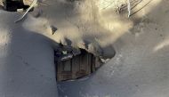 A house near the Tacande neighbourhood is surrounded by ash of the Cumbre Vieja volcano, on the Canary Island of La Palma, Spain, December 15, 2021. REUTERS/Marco Trujillo 