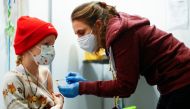 A nine-year-old girl receives a dose of the Pfizer-BioNTech vaccine for children against the coronavirus disease (COVID-19) during a vaccination event for children at the Lanxess Arena in Cologne, Germany, December 18, 2021. REUTERS/Thilo Schmuelgen
