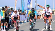 Competitors cross the finish line during the Dukhan Road Race.