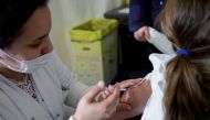 FILE PHOTO: A medical worker administers a dose of a coronavirus disease (COVID-19) vaccine to a child at a vaccination centre in Les Pavillons-sous-Bois, near Paris, France, December 18, 2021. REUTERS/Sarah Meyssonnier/File Photo

