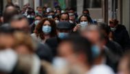 People wearing face masks queue to buy Christmas lottery tickets, amid the coronavirus disease (COVID-19) pandemic, in Madrid, Spain, December 20, 2021. Picture taken December 20, 2021. REUTERS/Susana Vera
