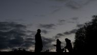 People walk in a public park as Austria's Government imposes new coronavirus disease (COVID-19) measures requiring people to wear masks outdoors when in crowd, in Vienna, Austria January 6, 2022. REUTERS/Leonhard Foeger/File Photo