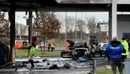 Police and specialists investigate the scene were two people were killed after a fire broke out in the pump area at a petrol station in Hammersbach, north-east of Frankfurt, Germany, January 17, 2022. REUTERS/Stringer 