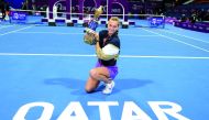 Petra Kvitova lifts the trophy after winning Qatar TotalEnergies Open 2021, in this file photo. 