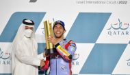 Chairman of Qatar Tourism and Qatar Airways Group Chief Executive, H E Akbar Al Baker presents the winner's trophy to Enea Bastianini.
