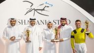 H H Sheikh Mohammed bin Khalifa Al Thani presents the trophy to Ibrahim Saeed Ibrahim Al Malki as QREC Chairman Issa bin Mohammed Al Mohannadi applauds following In The Night's triumph at QREC yesterday.