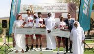 The officials and podium winners pose for a photograph.