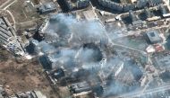 A satellite image shows burning apartment buildings in Mariupol, Ukraine, March 19, 2022. Satellite image ©2022 Maxar Technologies