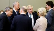Italy's Prime Minister Mario Draghi, NATO Secretary General Jens Stoltenberg, British Prime Minister Boris Johnson, Canada's Prime Minister Justin Trudeau, European Commission President Ursula von der Leyen and Germany's Chancellor Olaf Scholz speak before G7 leaders' family photo during a NATO summit on Russia's invasion of Ukraine, at the alliance's headquarters in Brussels, Belgium March 24, 2022. REUTERS/Henry Nicholls/Pool