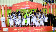 Al Sailiya's players and officials celebrate with the trophy after winning the final.