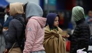 Ukrainian refugees wait outside a temporary shelter, after fleeing the Russian invasion of Ukraine, in Przemysl, Poland, March 29, 2022. REUTERS.