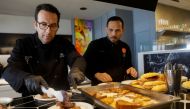 Spanish chef Ciriaco Vicente, 47, and his chef prepares sandwiches and sweets for Ukrainian refugees who come to eat at his restaurant on the beach in Valencia, Spain, March 28, 2022. Picture taken March 28, 2022. REUTERS/Eva Manez
