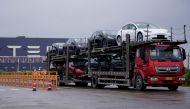 A truck transports new Tesla cars at its factory in Shanghai, China, May 13, 2021. REUTERS/Aly Song/File Photo