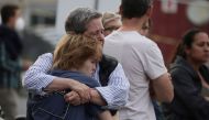 Family members hug and react emotionally as they wait at the family reunification center at the Cleveland Park Library for schoolchildren to be brought to the center after a shooting and active shooter near Edmund Burke Middle School in the Cleveland Park neighborhood of Northwest Washington, U.S., April 22, 2022. Reuters/Evelyn Hockstein